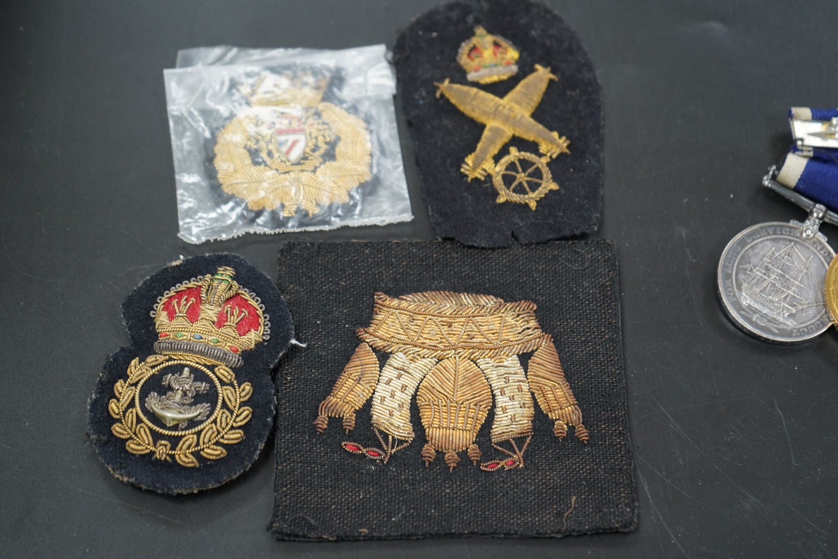 A WWI medal group including Good Conduct awarded to 226989 JHW.PUCKETT.PO.RN. (HMS PEMBROKE) together with cloth badges and a tag